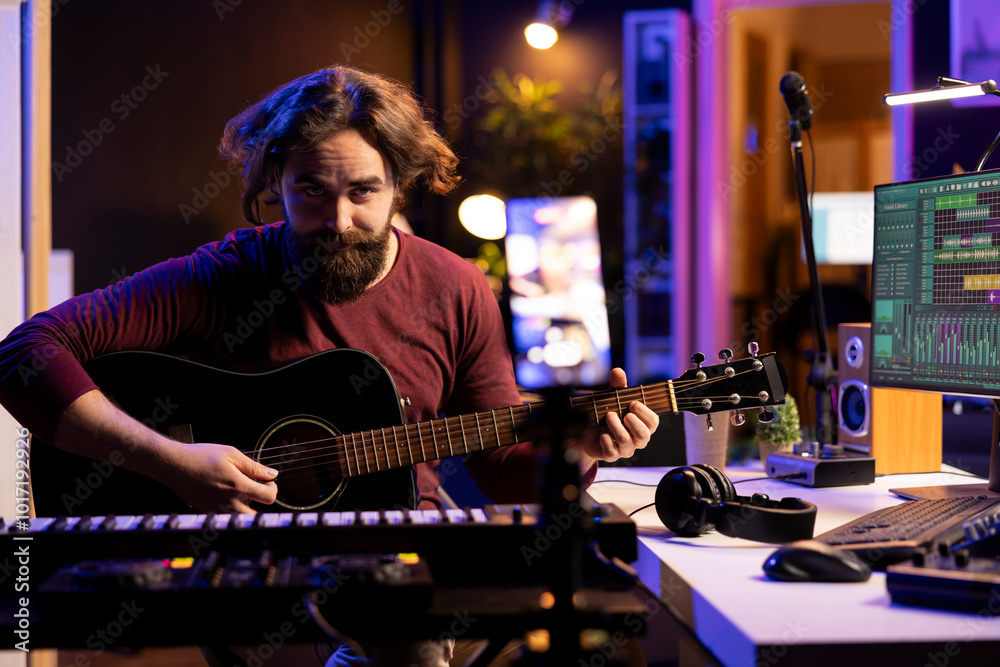 Poster guitarist instructor teaching guitar lessons on internet using smartphone, recording vlog as a tutor