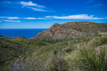 Serra de Tramuntana mountain landscape, Mallorca with sea in the background, wide angle shot, majorca