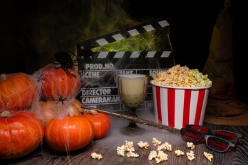 Cinema Theater Poster: Film Clapperboard, Watching Film Movie. Movie genre: horror, nightmares. Popcorn and Glasses from Cinema Theater. Halloween scene: Pumpkins, Mist, Fog, Smoke, Fire and Spiders
