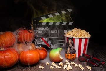 Cinema Theater Poster: Film Clapperboard, Watching Film Movie. Movie genre: horror, nightmares. Popcorn and Glasses from Cinema Theater. Halloween scene: Pumpkins, Mist, Fog, Smoke, Fire and Spiders