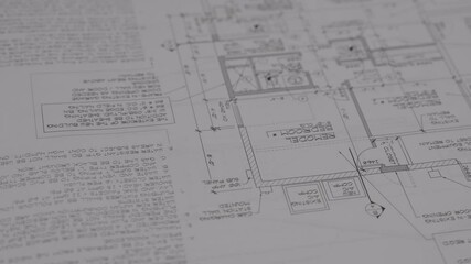 This close up video shows construction architectural blue print plans being unrolled. 
