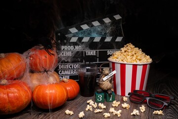 Cinema Theater Poster: Film Clapperboard, Watching Film Movie. Movie genre: horror, nightmares. Popcorn and Glasses from Cinema Theater. Halloween scene: Pumpkins, Mist, Fog, Smoke, Fire and Spiders
