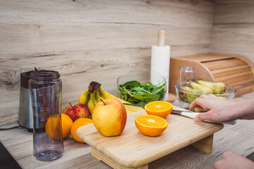 Healthy eating lifestyle concept photo of young woman preparing drink with fruit and vegetables at...