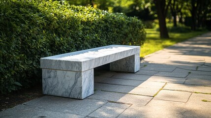 A polished white marble bench in a serene park setting, offering a peaceful place to sit.