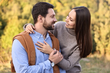 Fototapeta premium Beautiful couple spending time together outdoors on autumn day