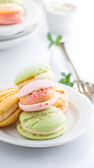 Colorful macaroons on a plate in a white kitchen