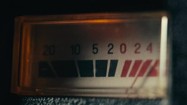 Retro sound level meter decibel meter in studio, vintage audio equipment, close up magnetic tape music player amplifier.
