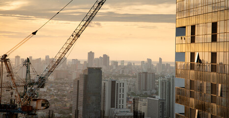 Sunset light reflecting off a modern skyscraper,in downtown Manila,Luzon,Philippines.