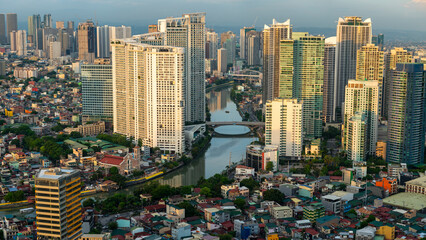 Naklejka premium Skyscrapers,lining the Pasig River in downtown Manila,Luzon,the Philippines.