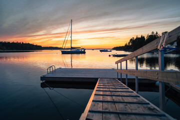 The sun sets at waters edge over Glen Margaret Bay
