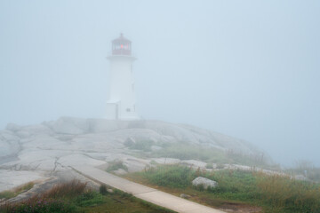 Peggy's Cove lighthouse sits solemnly in an Atlantic fog