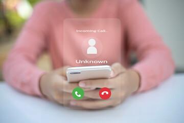 A person is holding a cell phone with a call screen that says 