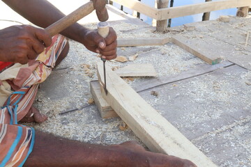 Wooden worker with equipment on farm