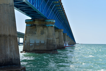 Blue bridge spanning ocean