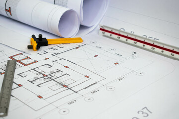 Architectural and construction plans. Technical drawings and measuring tools for building projects.