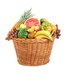 Many different fresh fruits in wicker basket isolated on white