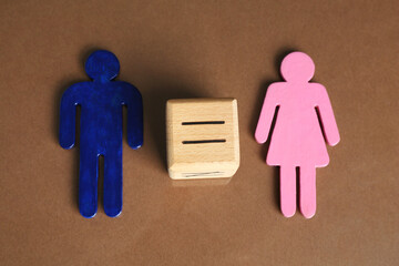 Gender equality concept. Male and female figures on brown background, above view