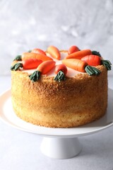 Delicious carrot cake on light grey table, closeup