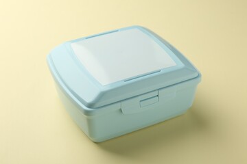 One light blue lunch box on beige background