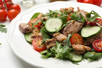 Delicious fresh tuna salad on white table, closeup