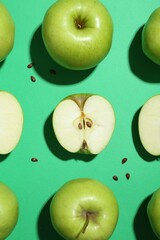 Flat lay composition with whole, cut apples and seeds on green background