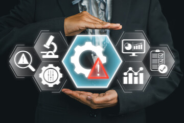 Businessman showcasing risk management concept using digital interface with warning symbol, gears, and data charts.