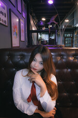 Beautiful brunette woman sitting in a city bar, enjoying the nightlife.