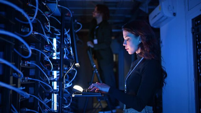 Woman programming in a server room