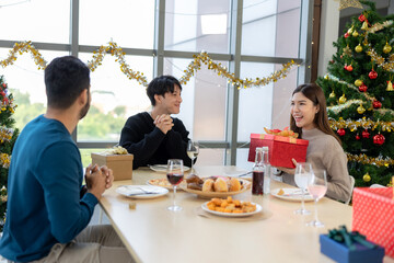 Asian friends come together to celebrate Christmas with a delightful dinner, sharing holiday traditions, festive food, and warm conversations, creating memorable moments of joy and togetherness.