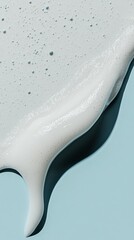 Obraz premium A detailed closeup of a facial cream being smoothed onto the skin with visible hydration effects, set against a light blue background for a fresh, clean aesthetic ideal for skincare brands.