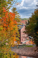 Old abandoned mill, forgotten in the heart of the Canadian forest in autumn