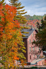 Old abandoned mill, forgotten in the heart of the Canadian forest in autumn