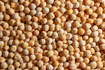 Uncooked Yellow Polished Peas Background. A Culinary Canvas of Dry Yellow Peas, Creating a Lively and Textured Background for Gourmet Cooking. Scattered Raw Polished Peas. Healthy Eating Ingredients