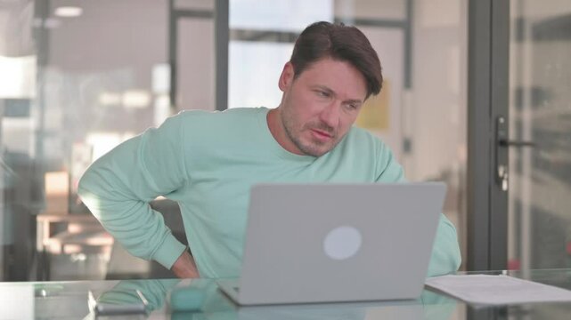 Man with Spinal Injury having Back Pain at Work