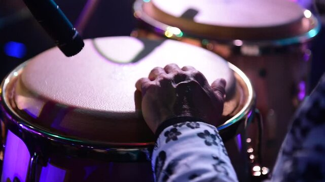 unrecognizable person playing congas, percussion musical instrument. concept band of cumbia, salsa, latin music.	Video.
