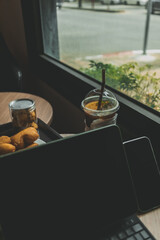 Computer tablet with desserts and Iced drink. Concept of working in a cafe.