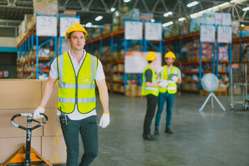 Three warehouse workers using a digital tablet while recording inventory. Logistics employees working with warehouse management software in a large distribution centre.