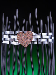 Close-up of a bright beautiful heart brooch in crystals on a dark background