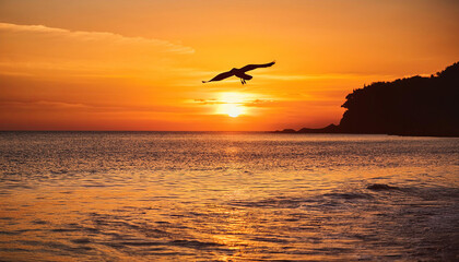Fototapeta premium bird flying over water at sunset, creating serene atmosphere