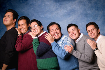Group of 6 men in sweater on blue background in 90's yearbook style. Posing in a romantic way
