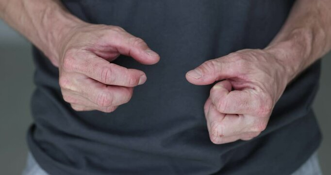 Man nervously moves hands clenching fists experiencing anxiety slow motion. Guy tries to cope with negative emotions feeling excitement