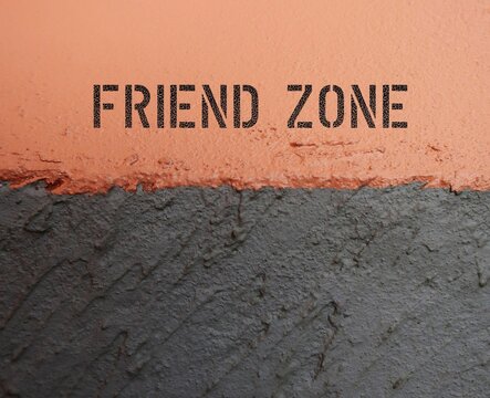 Grey painted wall background with text FRIEND ZONE - boundary set when someone want to have intimate romantic or sexual relationship one who want to be just friend, one side opposite sex attraction