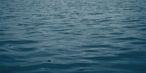 Naklejka premium Close-up of nature pattern, season and holiday. Concept of blue water and soft waves. Ocean flow background..