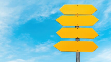 Bright yellow signs point the way against a clear blue sky, contrasting beautifully with soft, fluffy clouds in the background.