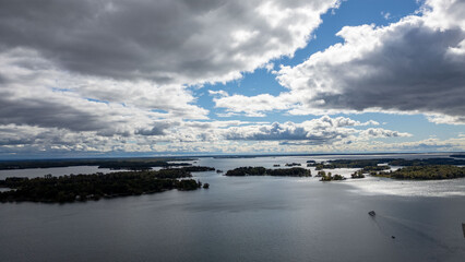 Stunning aerial views of the 1000 Islands region along the United States and Canada border, showcasing a mesmerizing landscape of lush green islands scattered across the blue waters of the St. Lawrenc