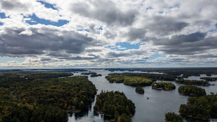 Stunning aerial views of the 1000 Islands region along the United States and Canada border, showcasing a mesmerizing landscape of lush green islands scattered across the blue waters of the St. Lawrenc