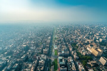 Obraz premium Aerial View of a Bustling Urban Landscape with Dense Architecture and Lush Green Spaces