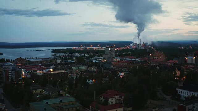 4K Drone Footage of the City Pite&aring;, Sweden, Late in the Evening, Factory Producing Smoke in the Background