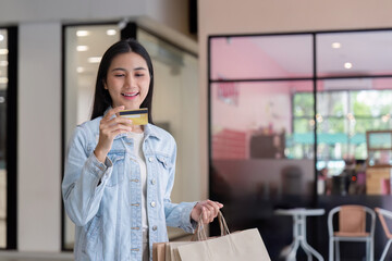 Happy Shopper Holding Credit Card and Shopping Bags During Black Friday