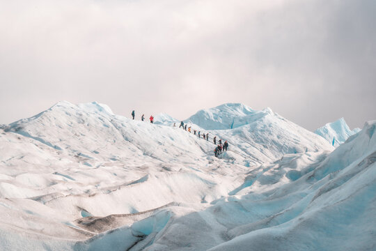 people walking on a glacier